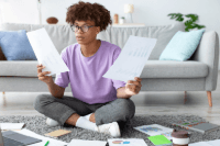 young adult looking over documents in apartment