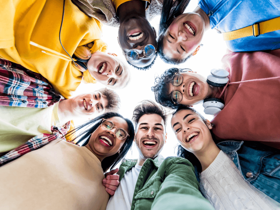 high school kids standing around eachother in a circle smiling